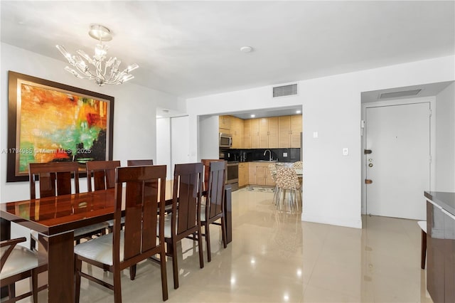 dining space with a chandelier, visible vents, and light tile patterned floors