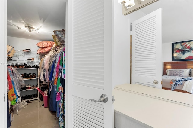 spacious closet featuring tile patterned flooring