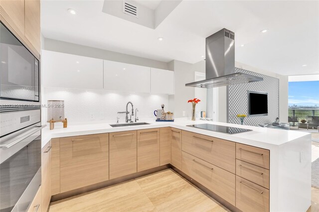 17111 Biscayne Blvd Unit 2208, Aventura, FL 33160 - kitchen with modern cabinets, oven, island range hood, black electric stovetop, and decorative backsplash