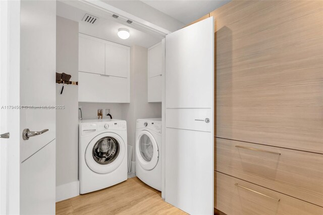 17111 Biscayne Blvd Unit 2208, Aventura, FL 33160 - laundry room with separate washer and dryer, light wood finished floors, and cabinet space