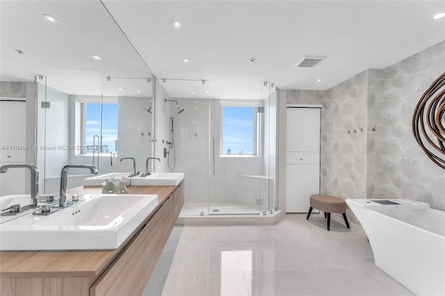 17111 Biscayne Blvd Unit 2208, Aventura, FL 33160 - bathroom with double vanity, visible vents, a freestanding tub, a stall shower, and a sink