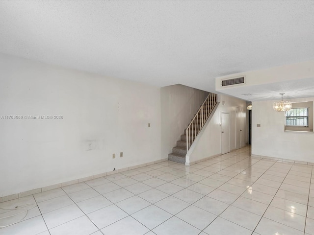 8000 SW 152nd Ave Unit 111, Miami, FL 33193 - spare room featuring a textured ceiling, visible vents, stairway, light tile patterned floors, and a notable chandelier