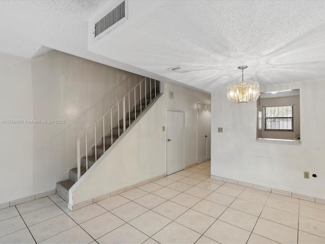 8000 SW 152nd Ave Unit 111, Miami, FL 33193 - interior space with visible vents, a textured ceiling, tile patterned flooring, and an inviting chandelier