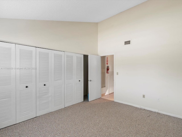8000 SW 152nd Ave Unit 111, Miami, FL 33193 - unfurnished bedroom featuring light colored carpet, high vaulted ceiling, baseboards, visible vents, and a closet
