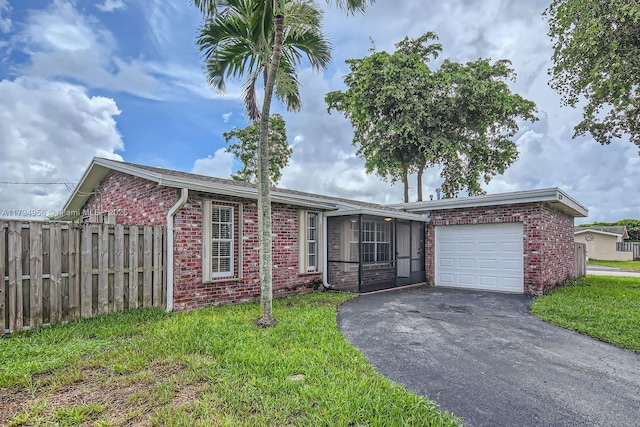4220 NW 114th Ave, Sunrise, FL 33323 - single story home featuring a front yard, a garage, brick siding, fence, and aphalt driveway