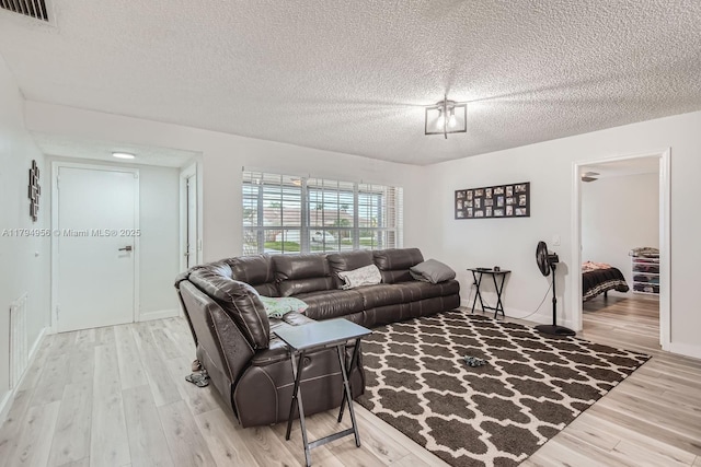 4220 NW 114th Ave, Sunrise, FL 33323 - living area with a textured ceiling, visible vents, and light wood-type flooring