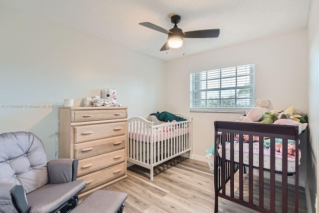 4220 NW 114th Ave, Sunrise, FL 33323 - bedroom with a textured ceiling, ceiling fan, and light wood finished floors