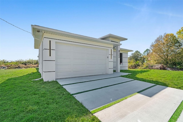 view of front of home featuring concrete driveway, a garage, and a front lawn