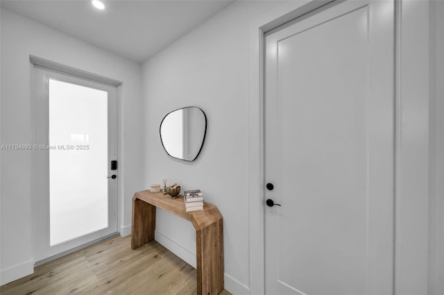foyer featuring recessed lighting, baseboards, and light wood finished floors