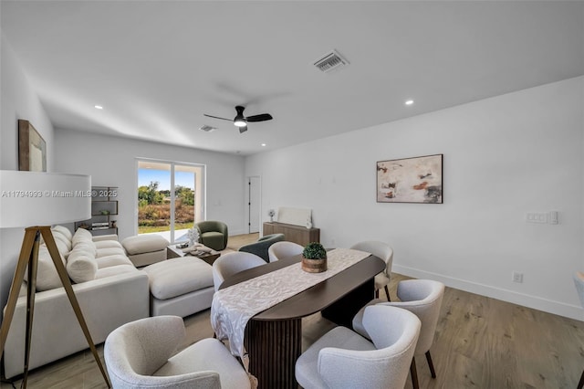 dining area with visible vents, light wood-style flooring, baseboards, and ceiling fan