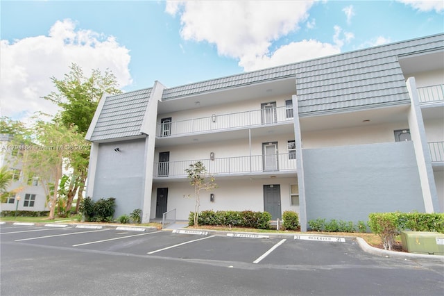 view of property featuring uncovered parking