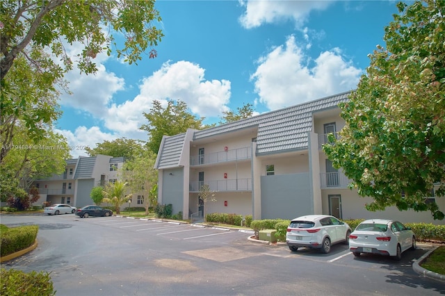 9150 Lime Bay Blvd Unit 201, Tamarac, FL 33321 - view of building exterior featuring uncovered parking