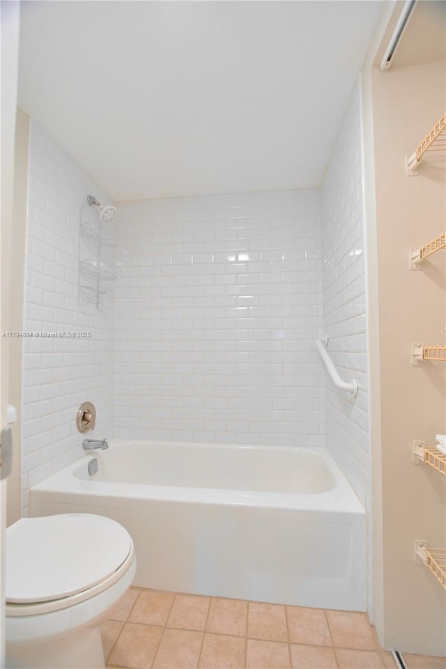 bathroom with tile patterned floors, toilet, and  shower combination