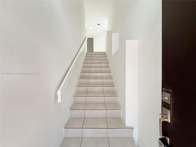 staircase with tile patterned flooring
