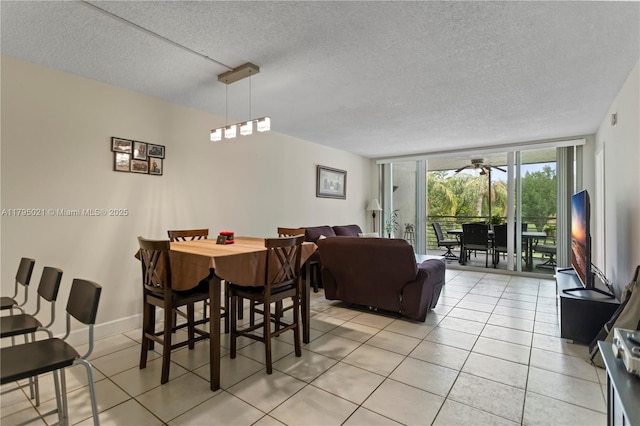 9501 Seagrape Dr Unit 205, Davie, FL 33324 - dining area with expansive windows, a textured ceiling, baseboards, and light tile patterned flooring