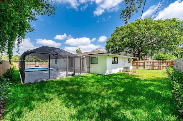back of property featuring a fenced backyard, central air condition unit, stucco siding, and a yard
