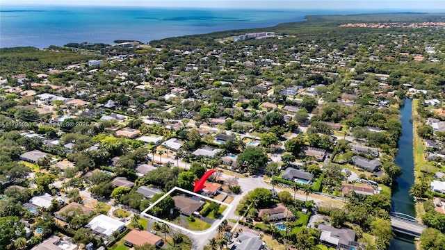 birds eye view of property with a water view and a residential view