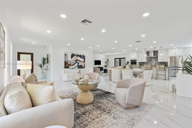 living room with recessed lighting, marble finish floor, and visible vents