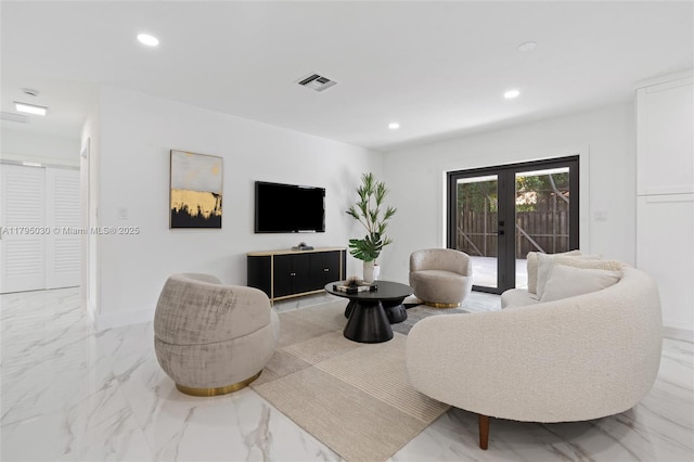 living area with recessed lighting, visible vents, and marble finish floor