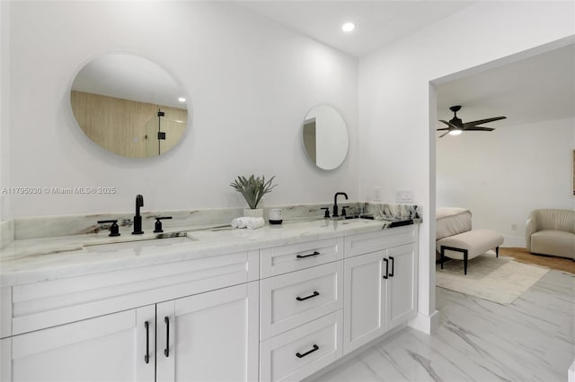 full bathroom featuring a sink, ceiling fan, double vanity, and marble finish floor