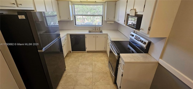 10207 Sunrise Lakes Blvd Unit 307, Sunrise, FL 33322 - kitchen with black appliances, light countertops, white cabinetry, and light tile patterned flooring