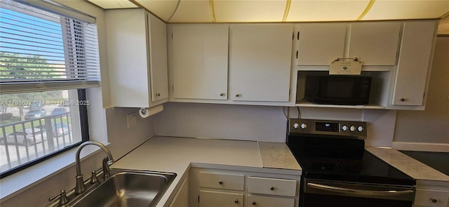 10207 Sunrise Lakes Blvd Unit 307, Sunrise, FL 33322 - kitchen featuring electric stove, black microwave, and light countertops