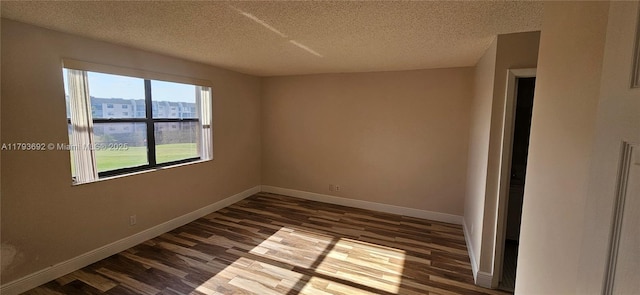10207 Sunrise Lakes Blvd Unit 307, Sunrise, FL 33322 - unfurnished room with dark wood finished floors and a textured ceiling