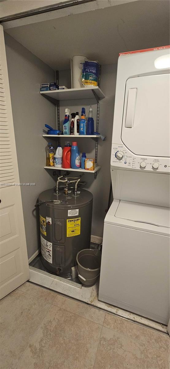10207 Sunrise Lakes Blvd Unit 307, Sunrise, FL 33322 - laundry area featuring electric water heater and stacked washing machine and dryer