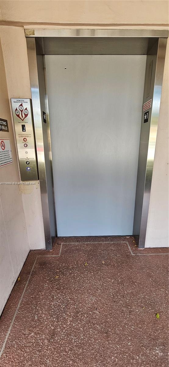 10207 Sunrise Lakes Blvd Unit 307, Sunrise, FL 33322 - corridor featuring speckled floor and elevator