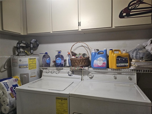 clothes washing area with cabinet space, water heater, and independent washer and dryer