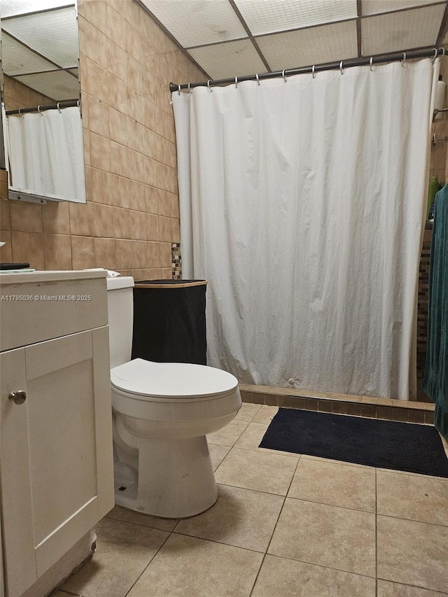 bathroom with toilet, tile patterned floors, a shower with curtain, and vanity