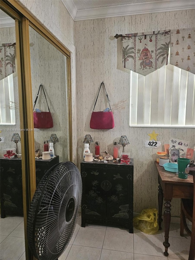 interior space featuring a closet, ornamental molding, and tile patterned floors