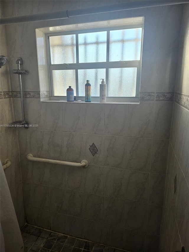 bathroom with tiled shower
