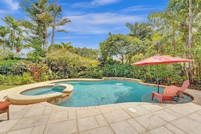 view of swimming pool with a pool with connected hot tub and a patio area