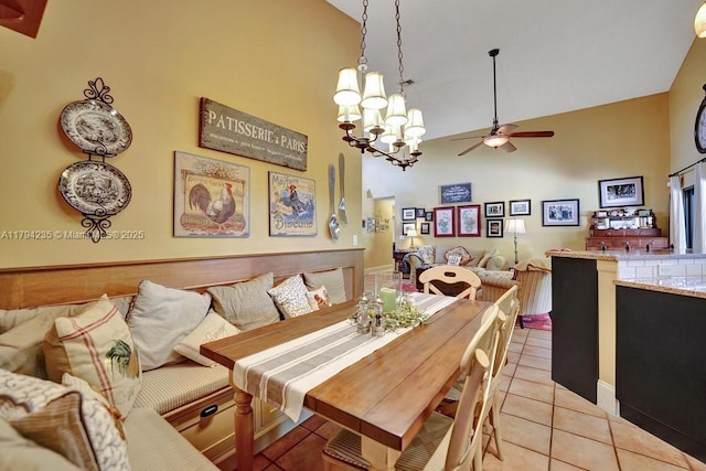 dining space with light tile patterned floors, high vaulted ceiling, and ceiling fan