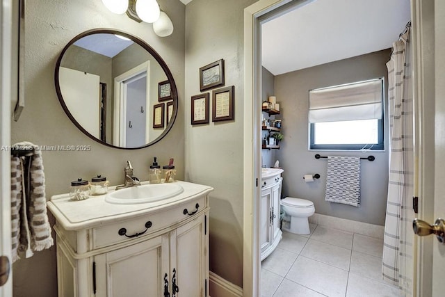 full bath featuring vanity, tile patterned floors, and toilet