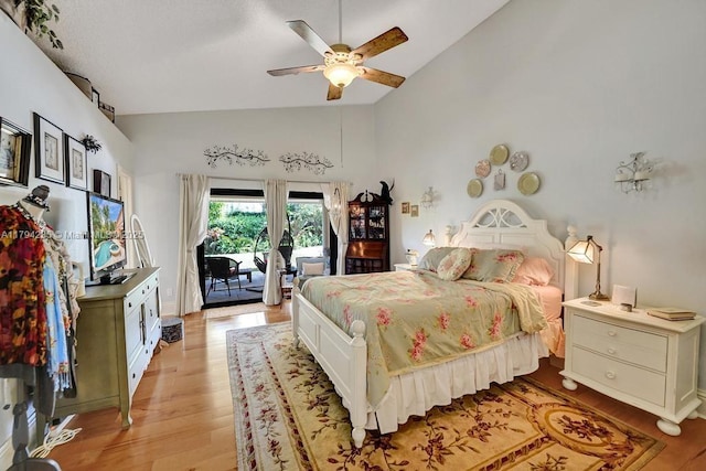 bedroom featuring high vaulted ceiling, access to outside, a ceiling fan, and light wood finished floors