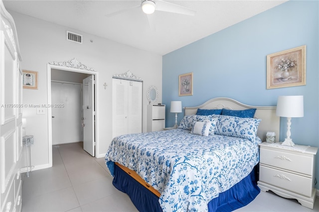 tiled bedroom with a ceiling fan, a closet, and visible vents