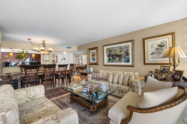 21075 NE 34th Ave Unit 306-2, Aventura, FL 33180 - living area featuring visible vents and an inviting chandelier