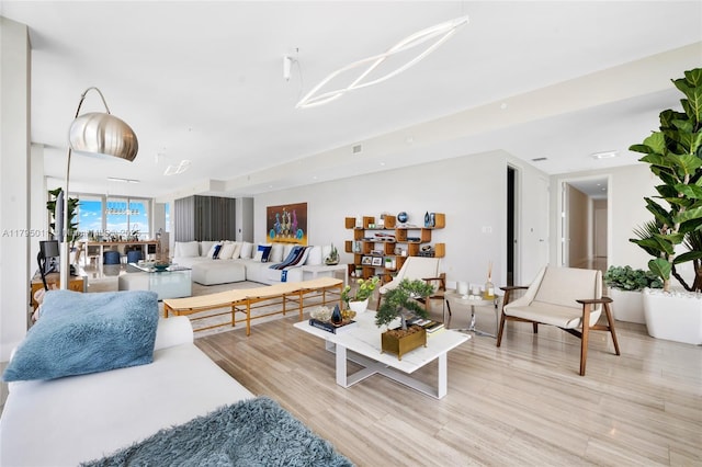 living room featuring wood finished floors and a chandelier