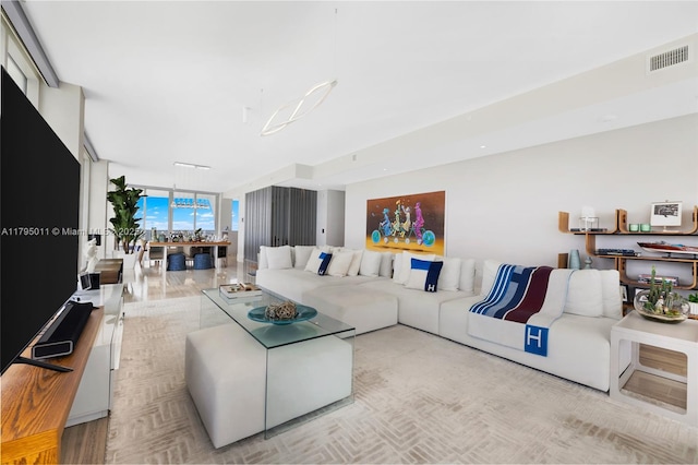 living room featuring expansive windows and visible vents