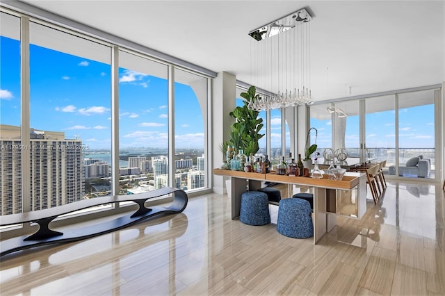 dining room with expansive windows, a city view, a water view, and a wealth of natural light