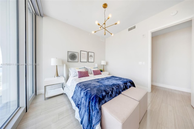 bedroom featuring baseboards, visible vents, and an inviting chandelier