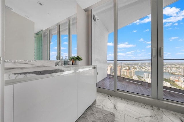 bathroom featuring visible vents, a sink, and marble finish floor