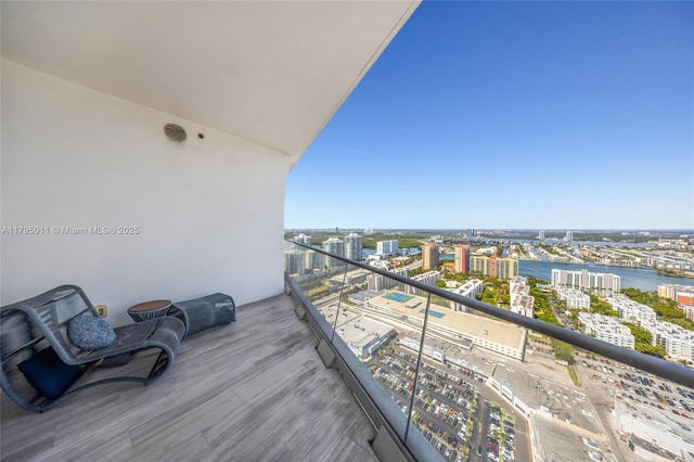 balcony featuring a view of city and a water view