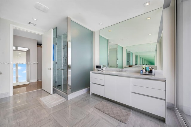 full bath with visible vents, tile patterned flooring, a stall shower, vanity, and baseboards