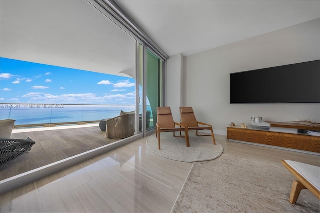 interior space with baseboards, floor to ceiling windows, and wood finished floors