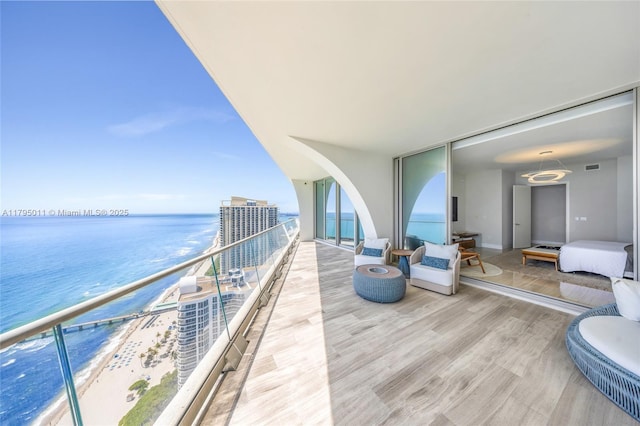 balcony featuring visible vents and a water view
