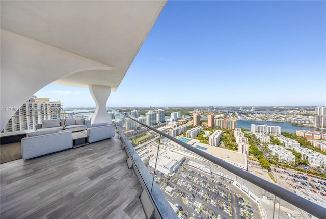 balcony featuring a city view and a water view
