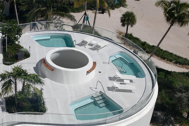 view of pool with a jacuzzi